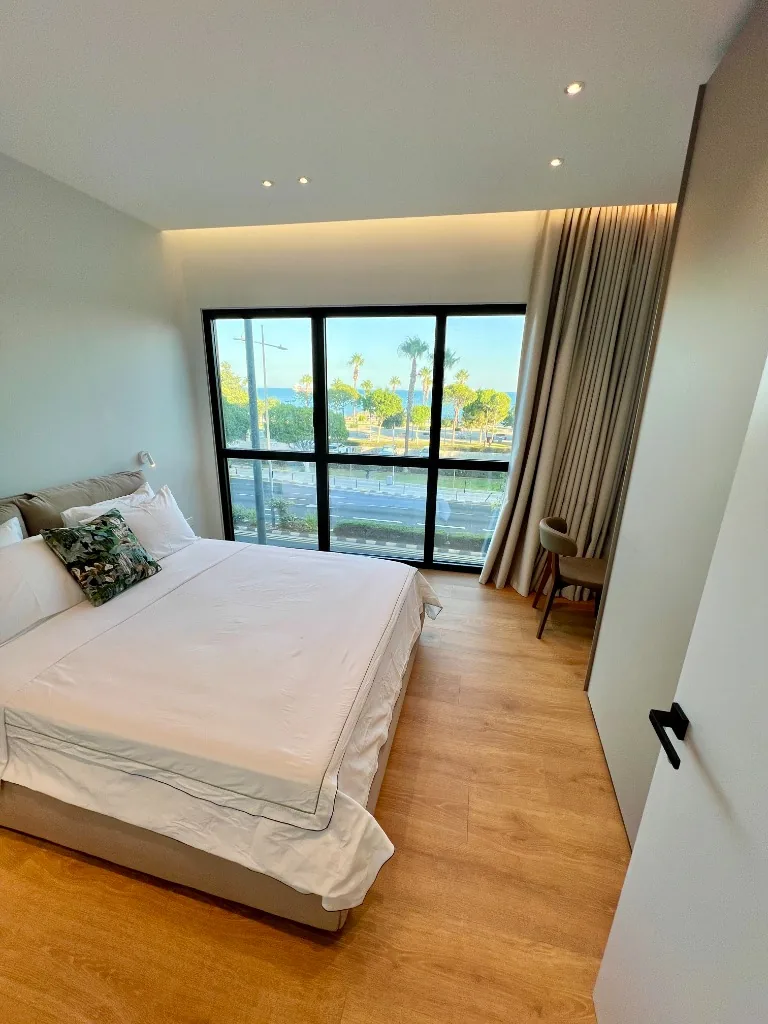The Horizon Suite master bedroom with floor-to-ceiling coastal view